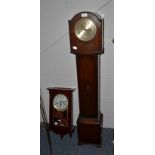 A small chiming longcase clock and a modern striking wall clock (2)