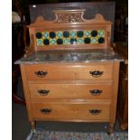 An early 20th century marble topped oak washstand with tiled splashback