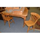 A pine kitchen table and four chairs