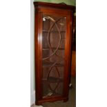 A George III mahogany standing corner cabinet