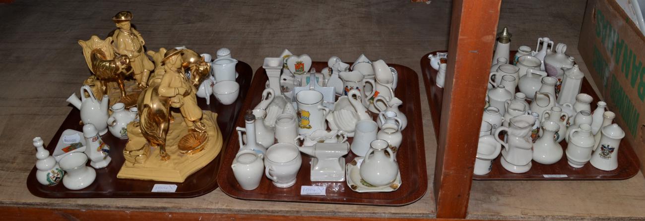 A collection of crested china and a pair of Eichwald pottery pipe racks