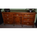 A Georgian oak sideboard Some water damage to each side. Large chip to left hand side of base.