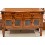 A Hardwood Sideboard of recent date, with two frieze drawers above four cupboard doors, raised on