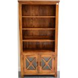 A Reproduction Hardwood Free-Standing Bookcase, with three fixed shelves above glazed cupboard