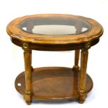 A Walnut Two-Tier Oval Lamp Table, with bevelled glass plate above reeded tapering legs joined by