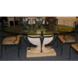 An Egyptian Revival Dining Table of recent date, with an oval glass top above caryatid supports