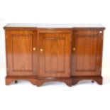 A Reproduction Mahogany Breakfront Sideboard, with plate glass top above a pull-out slide with three