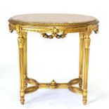 A Gilt and Pink Marble Oval Centre Table of recent date, raised on acanthus and fluted tapering legs