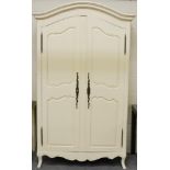 A Cream Painted Armoire of Recent Date with moulded canopy top above panel doors enclosing