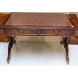 A Reproduction Mahogany Writing Table, in Regency style, with brown leather writing surface above