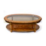 A Reproduction Walnut Oval Coffee Table, with bevelled glass plate, reeded tapering supports