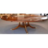 A Regency Style Mahogany Extending Circular Dining Table, of recent date, the crossbanded top with