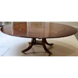 A Mahogany Jupe Style Circular Dining Table of recent date, five removable leaves over four