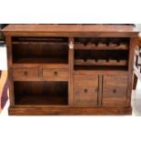 A Hardwood Wine Rack of recent date, the bottle rack above two small drawers and two cupboard doors,