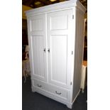 A White Painted Double Door Wardrobe of recent date, panel doors enclosing a hanging rail and