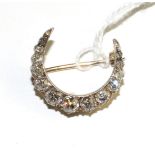 A diamond crescent brooch, set throughout with old cut and rose cut diamonds in collet and claw