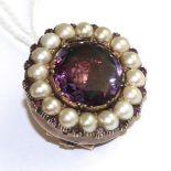 An amethyst and split pearl brooch, an oval cut foil backed amethyst in a yellow collet and claw