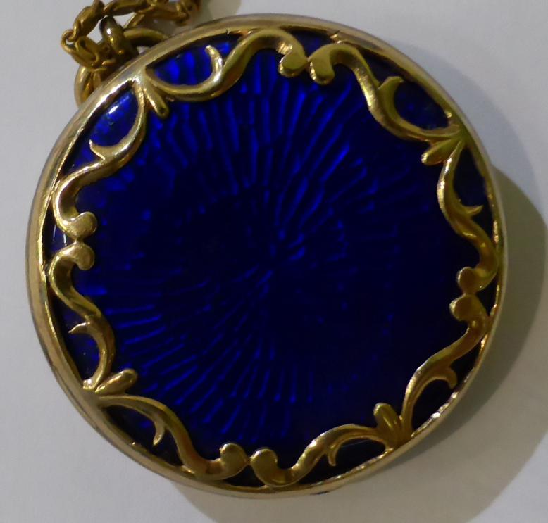 A blue guilloche enamel locket, a circlar locket with applied scroll decoration, hinged to open - Image 3 of 4