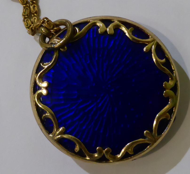 A blue guilloche enamel locket, a circlar locket with applied scroll decoration, hinged to open - Image 2 of 4
