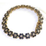 A sapphire and diamond bracelet, of flowerhead clusters, each with a round brilliant cut diamond