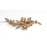 A pearl spray brooch, a floral spray set throughout with seed pearls, measures 6.6cm x 2.3cm One