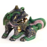 A Chinese porcelain lion dog seated, decorated in blue, green and gilt, 19cm high, converted to a