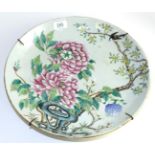 A Chinese porcelain sauce dish, Kangxi reign mark but not of the period, painted with famille rose