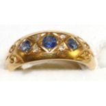 An 18 carat gold sapphire and diamond ring, three graduated round cut sapphires spaced by eight-