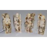 A set of four Japanese carved ivory figures of Immortals, early 20th century, each holding a