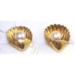 A pair of cultured pearl shell earrings, a single cultured pearl within a yellow shell stud, with