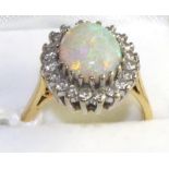 An opal and diamond cluster ring, an oval cabochon opal within a border of eight-cut diamonds in