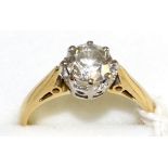 An 18 carat gold diamond solitaire ring, a round brilliant cut diamond in a white claw setting