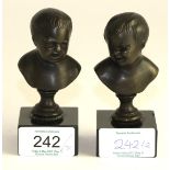 A pair of bronze busts of children after Roubillac, on circular pedestals and black marble bases,