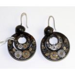 A pair of tortoiseshell and pique work earrings, a domed stud suspends two discs, decorated