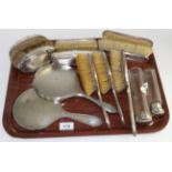 Thirteen silver backed dressing table items to include seven brushes, two hand mirrors, an oval