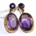 A pair of amethyst earrings, a round cut amethyst suspends a larger oval cut amethyst in yellow