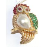 A multi-gemstone owl brooch, set with marquise and pear cut rubies, round cut emeralds, round
