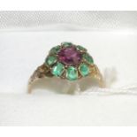 A Victorian 12 carat gold rhodolite garnet and green paste ring, a round cut garnet within a