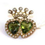 A peridot and seed pearl double heart brooch, two heart cut peridot within seed pearl borders and
