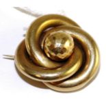 A Victorian knot brooch, a central faceted sphere within a knot frame, with a glazed locket to the