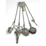 A Victorian silver chatelaine comprising thimble holder, pair of scissors, aid memoir, pencil and