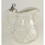 A white metal mounted cut glass lemonade jug, early 20th century, of pear shape with scroll thumb
