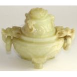 A Chinese carved jade vase and cover with handles in the form of dogs of foe, with loop handles,
