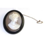 A carved shell cameo brooch, the oval cameo depicting a female bust with ears of wheat in her