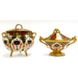 A Royal Crown Derby Old Imari swing handled biscuit jar and cover, raised on three legs, together