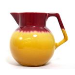 Christopher Dresser for Linthorpe Pottery: A Jug, shape No.783, mustard and deep pink glaze,