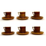 Christopher Dresser for Linthorpe Pottery: A Set of Six Cups and Saucers, shape No.640, mustard
