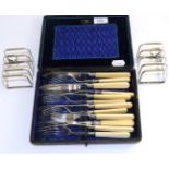 Six pairs of silver fish knives and forks, Sheffield 1907; and a pair of silver toast racks,