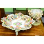 A Continental porcelain floral encrusted bowl and a similar bowl with putti supports