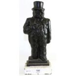 A painted cast iron door stop modelled as Winston Churchill standing wearing a top hat and smoking a